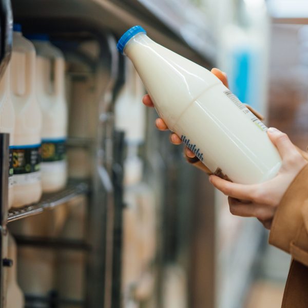 close-up-shot-of-woman-holding-a-bottle-of-organic-fresh-milk-in-supermarket-1303924236-12090295caf54c46a0f3ee942d75f6bc.jpg