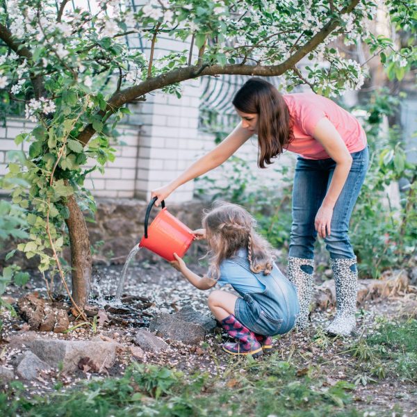motheranddaughterwateringatreeingarden-5ac5b8eadcdf446e9af7349779a28820.jpg