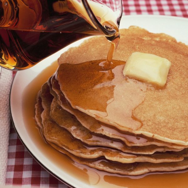 pouring-maple-syrup-on-plate-of-pancakes-522241854-ee9674fc9ad44e2ca2787719afbda4eb.jpg